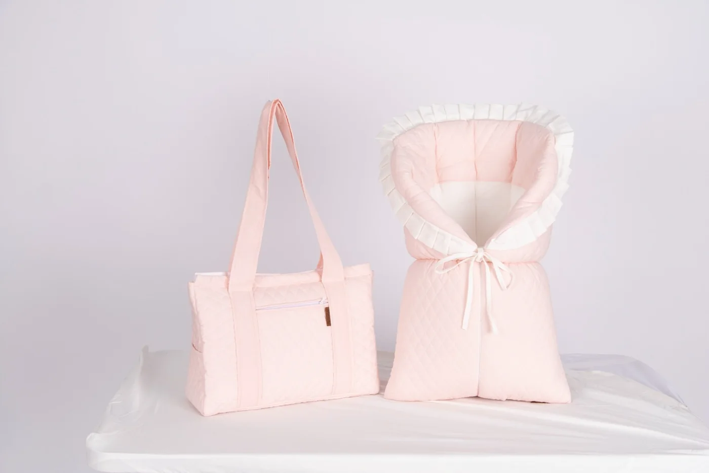 Blush newborn wrap and matching quilted bag