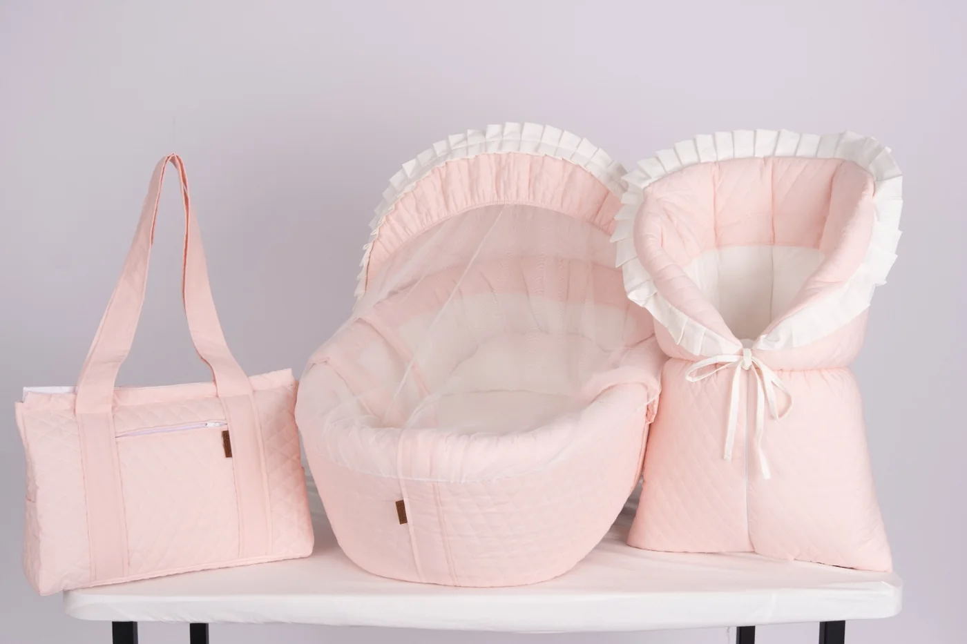 Matching quilted bassinet, newborn wrap and diaper bag